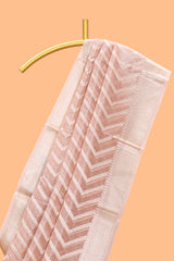 Peach color geometric design art tissue saree with contrast zari border and matching blouse