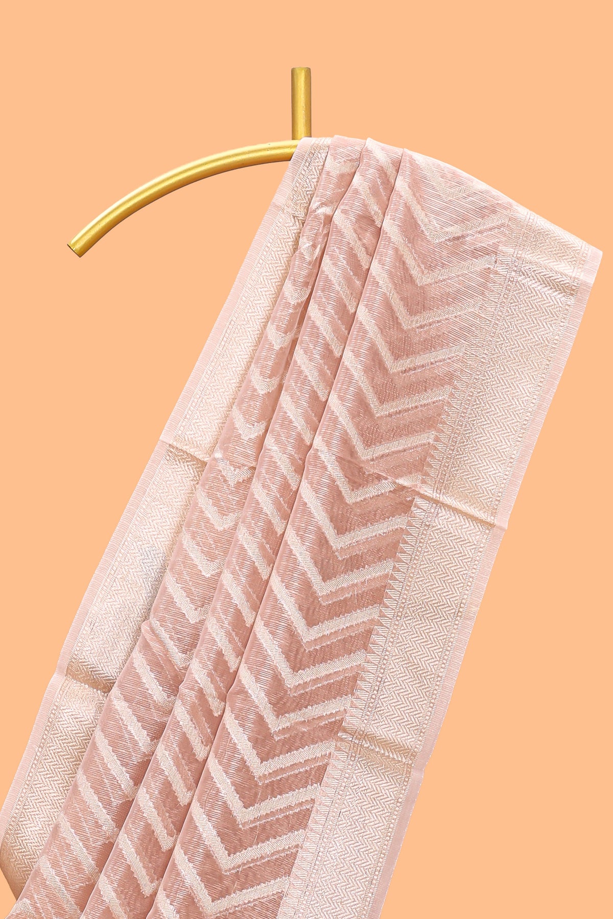 Peach color geometric design art tissue saree with contrast zari border and matching blouse