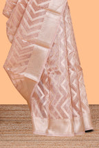 Peach color geometric design art tissue saree with contrast zari border and matching blouse
