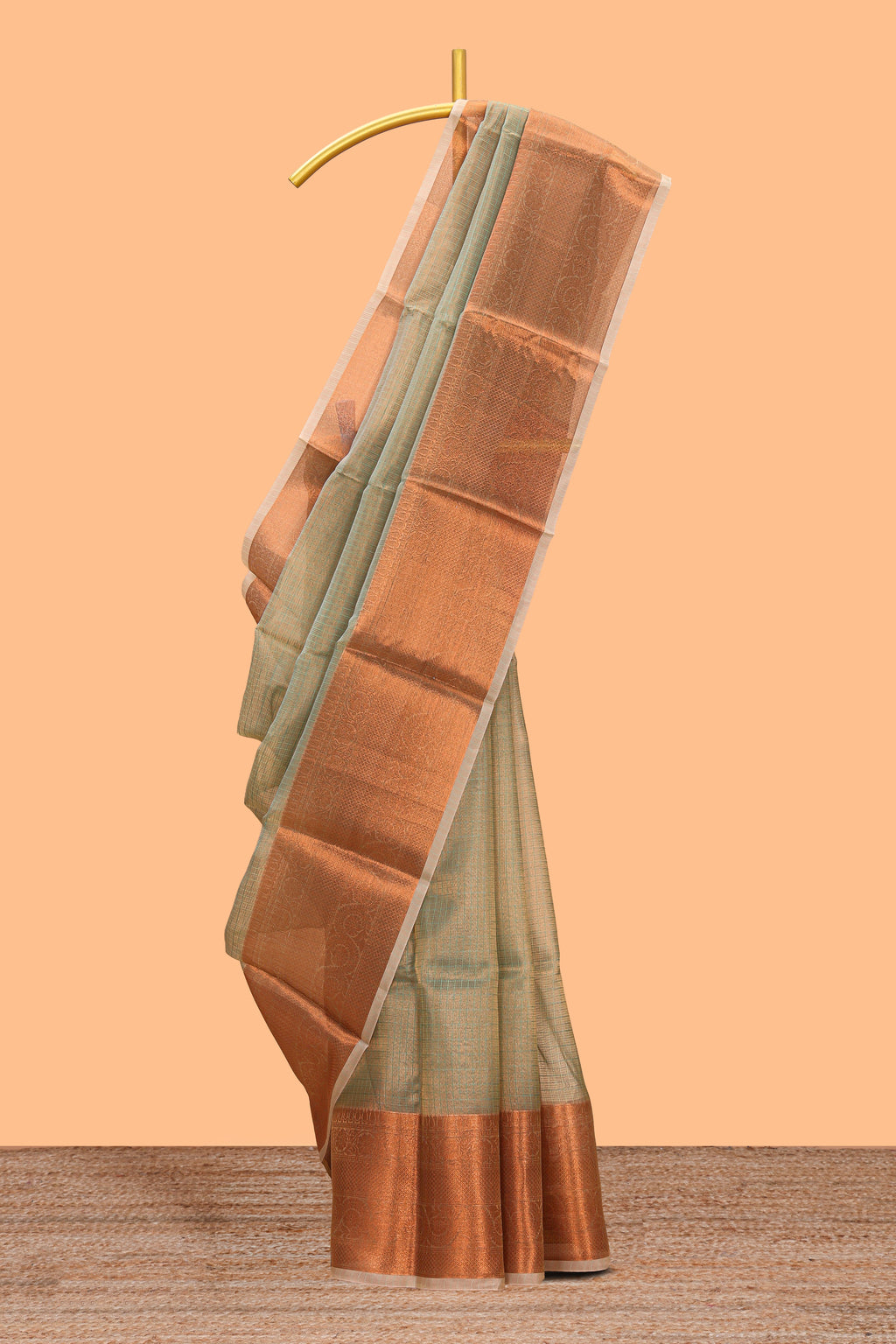 Muted green checked art tissue saree with contrast rust orange border and blouse