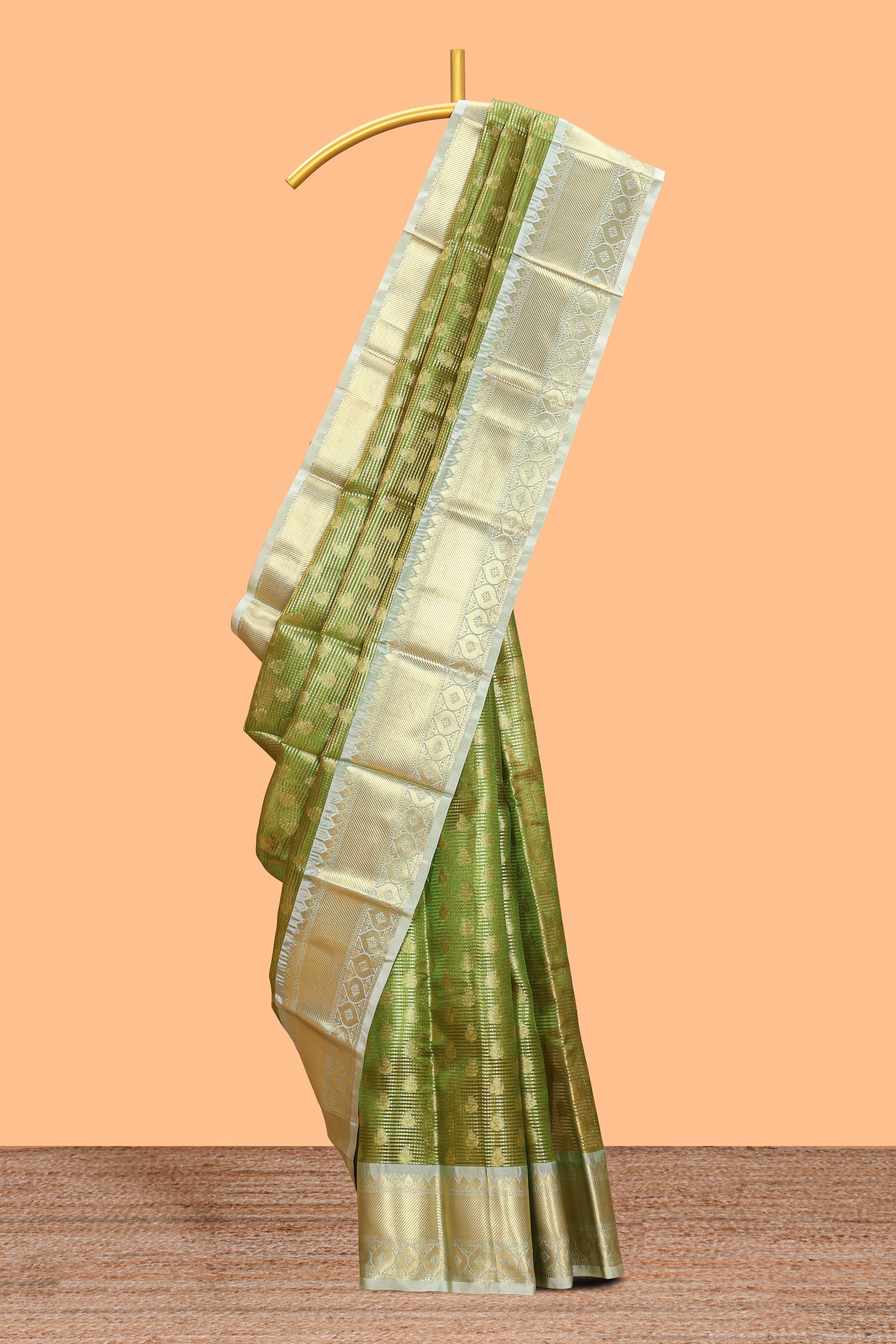 Green butta designs and striped art tissue saree with contrast zari border and blouse