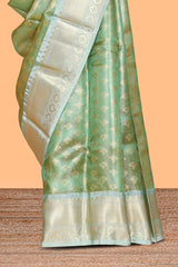 Green zari motifs design art tissue saree with contrast zari border and motifs blouse