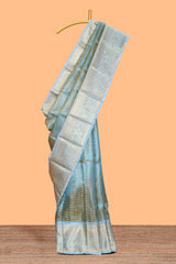 Blue zari design art tissue saree with self zari border and contrast blouse