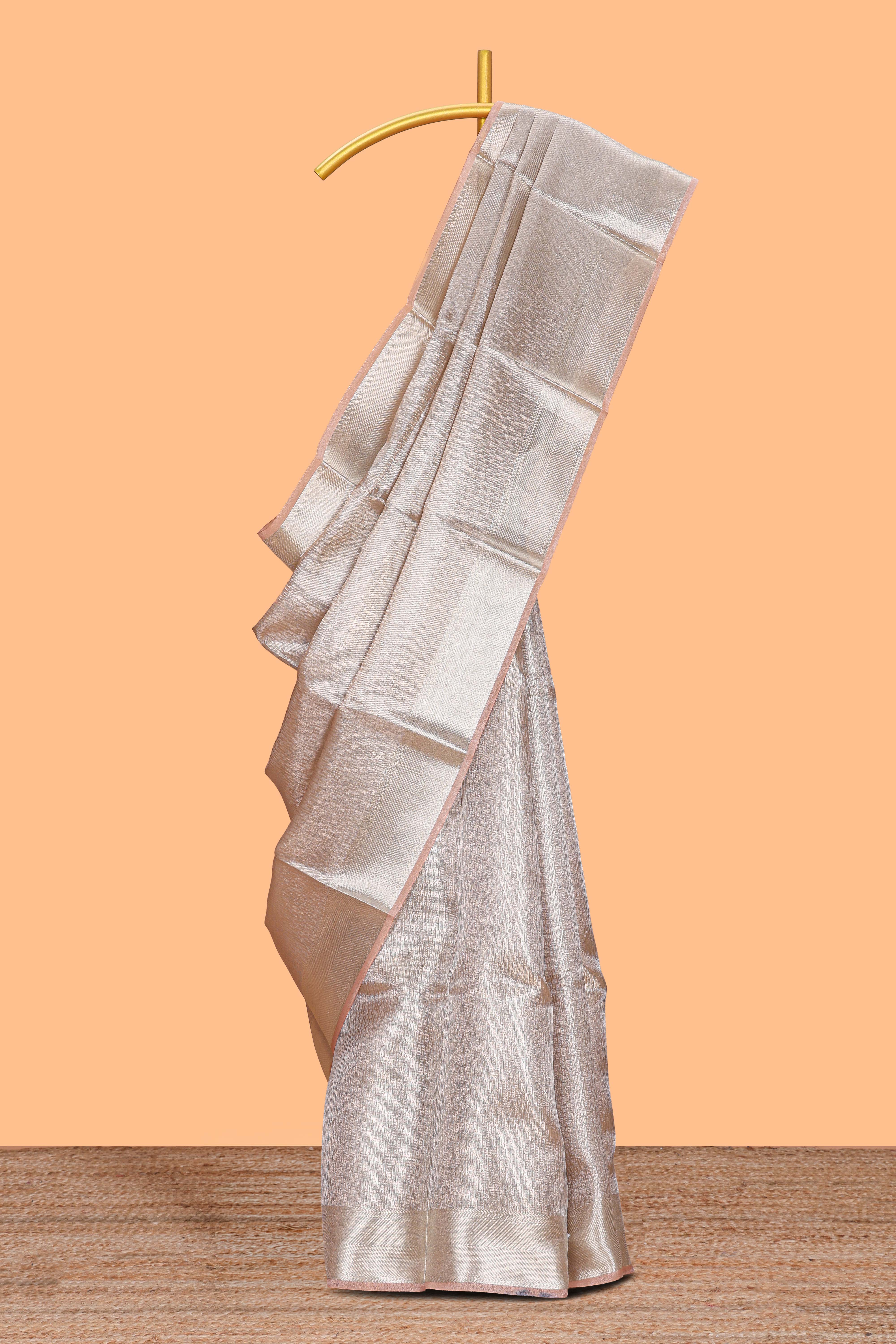 Beige geometric zari design art tissue saree with self zari border and matching blouse