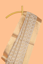 Gold shade geometric design art tissue saree with self zari border and matching blouse