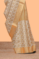 Gold shade geometric design art tissue saree with self zari border and matching blouse