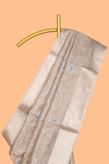 Beige color floral design are tissue saree with self zari border matching plain blouse