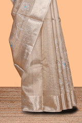 Beige color floral design are tissue saree with self zari border matching plain blouse