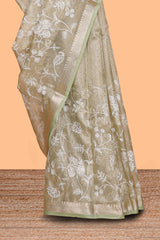Pale green floral design art tissue saree with self zari border and plain blouse