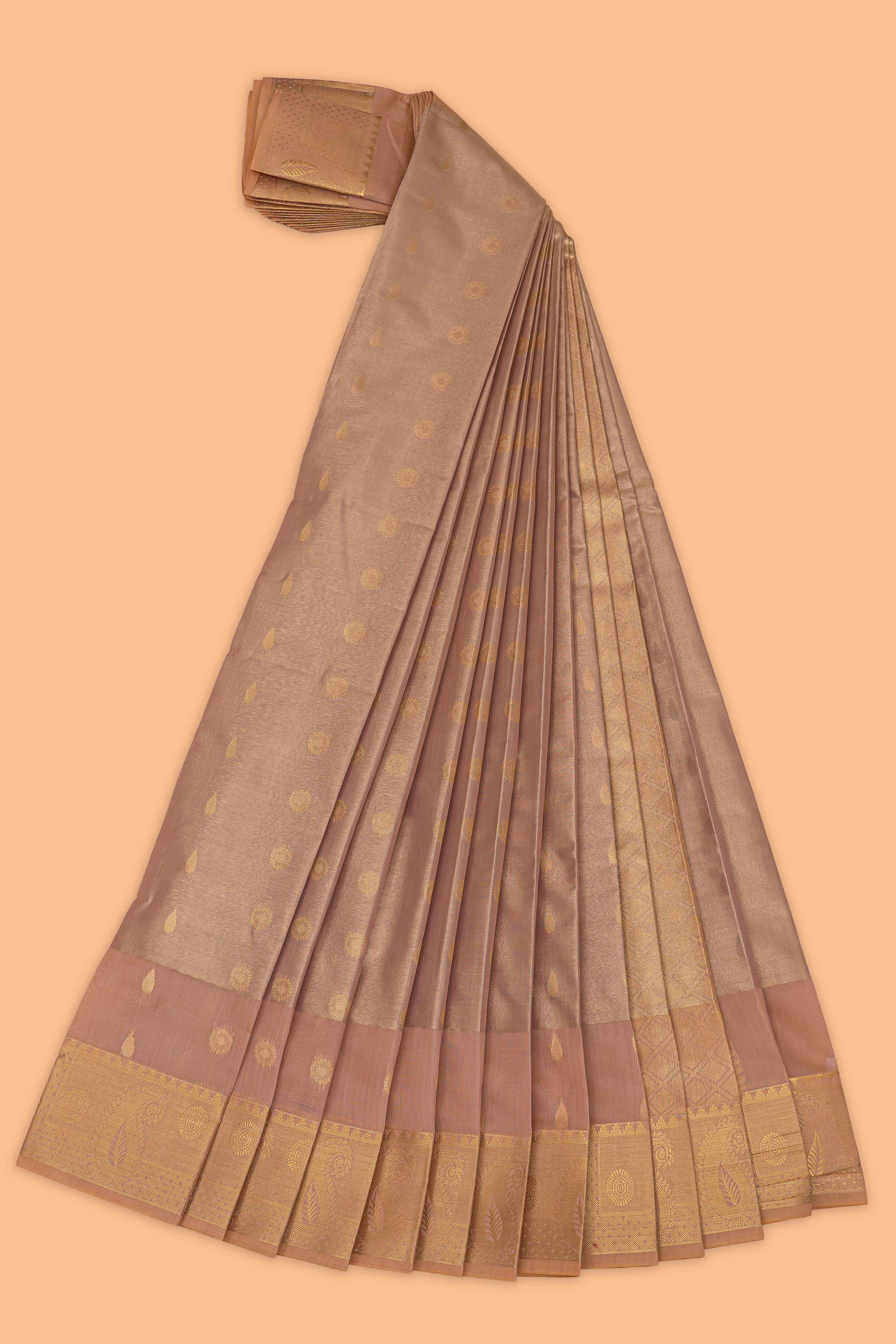 Faded peach motifs design tissue saree with contrast border and matching blouse