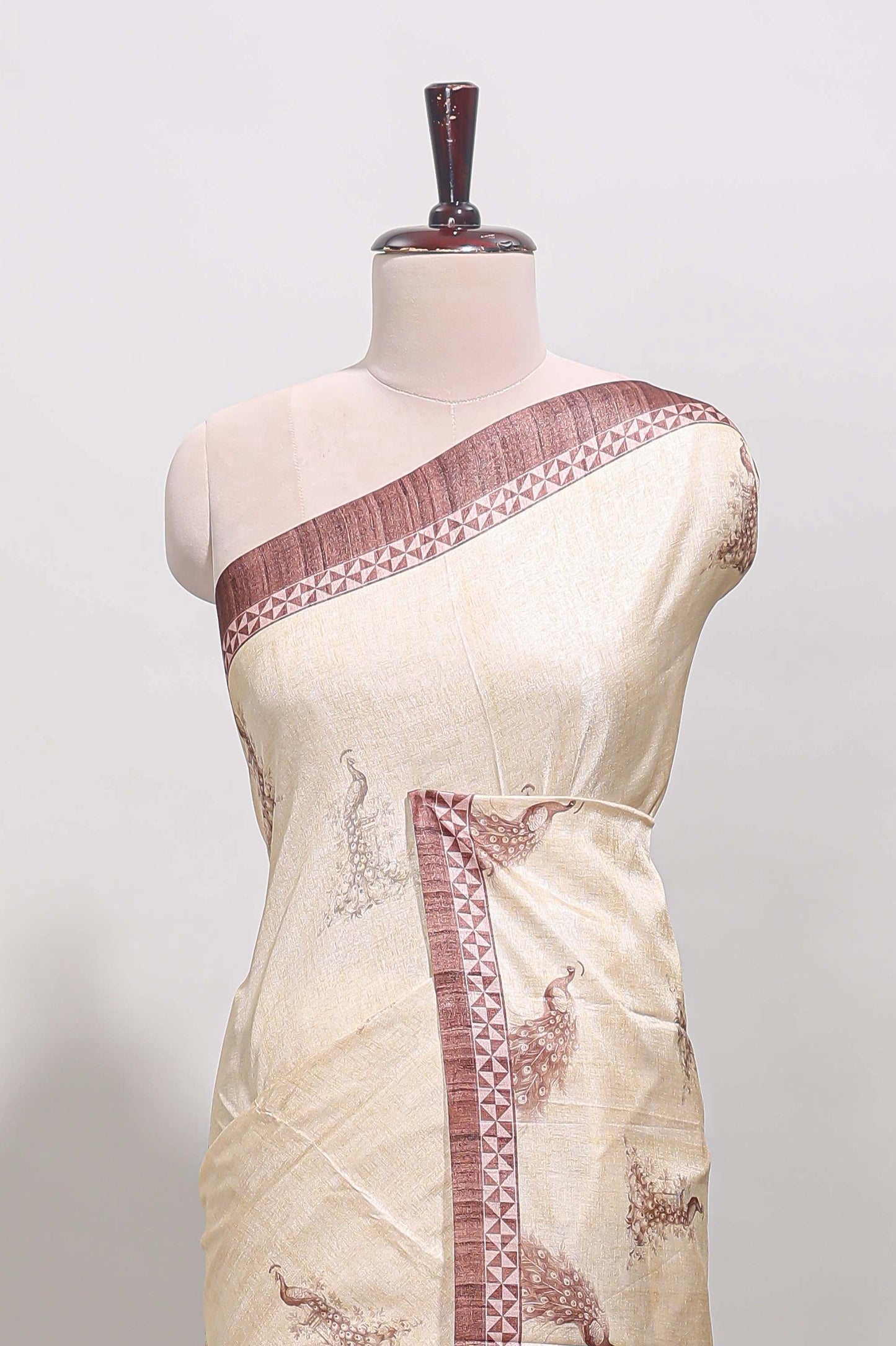Cream peacock motifs tussar saree with contrast brown border and peacock printed pallu