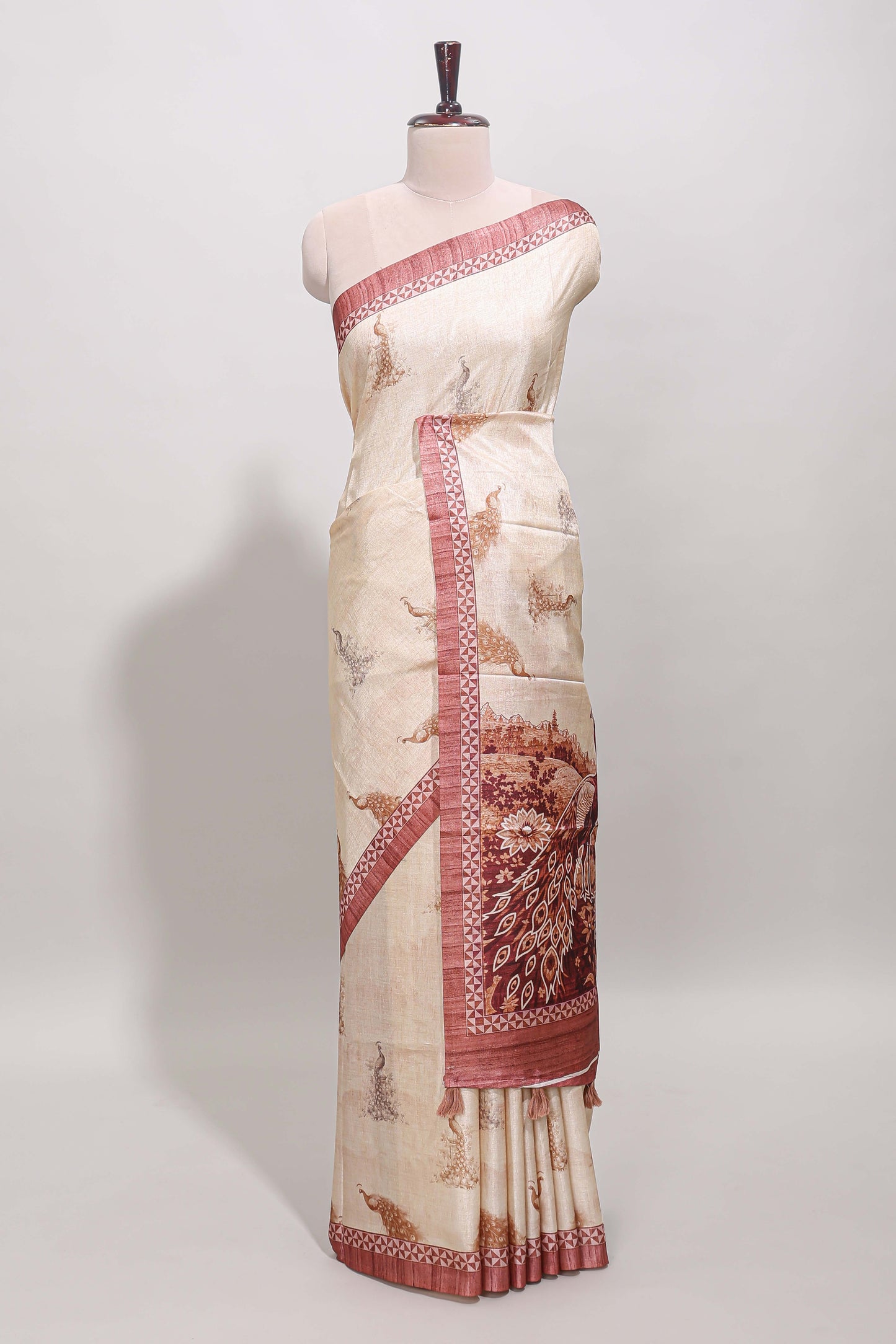 Cream peacock motifs tussar saree with contrast peach border and peacock printed pallu