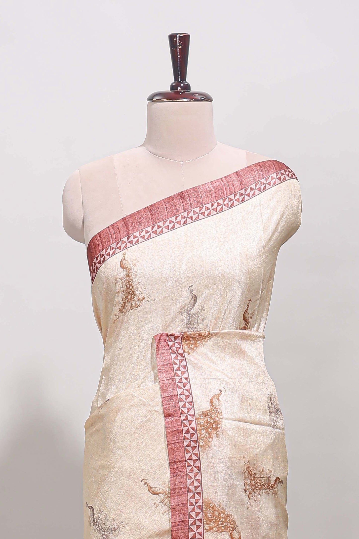 Cream peacock motifs tussar saree with contrast peach border and peacock printed pallu