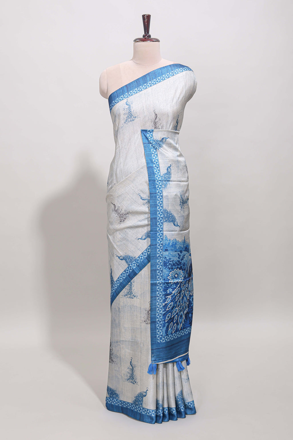 Cream peacock motifs tussar saree with contrast blue border and peacock printed pallu