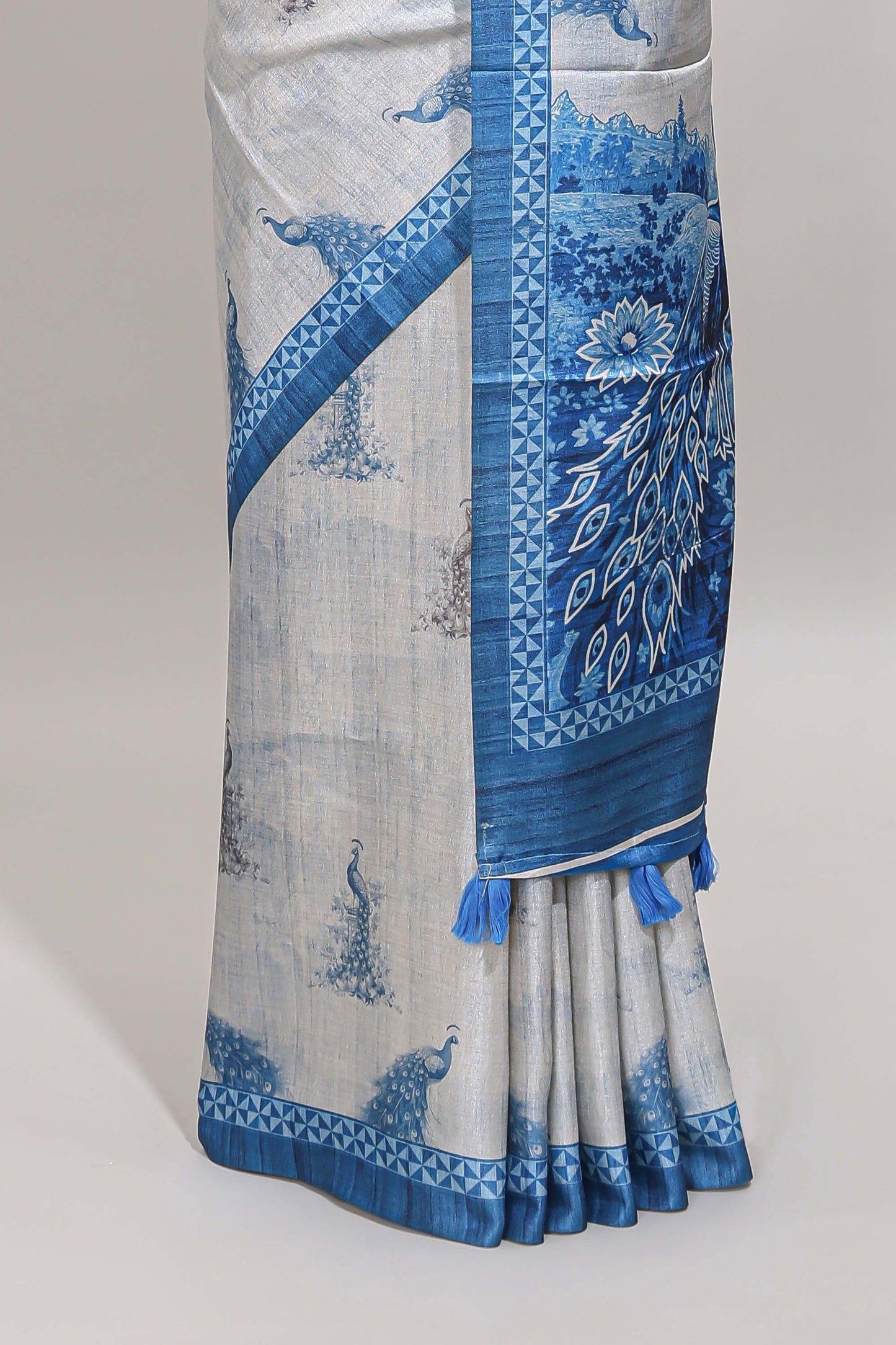 Cream peacock motifs tussar saree with contrast blue border and peacock printed pallu