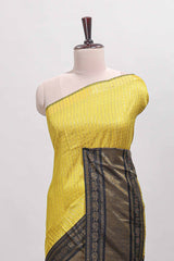 Yellow checked tussar saree with contrast black zari border and checked blouse