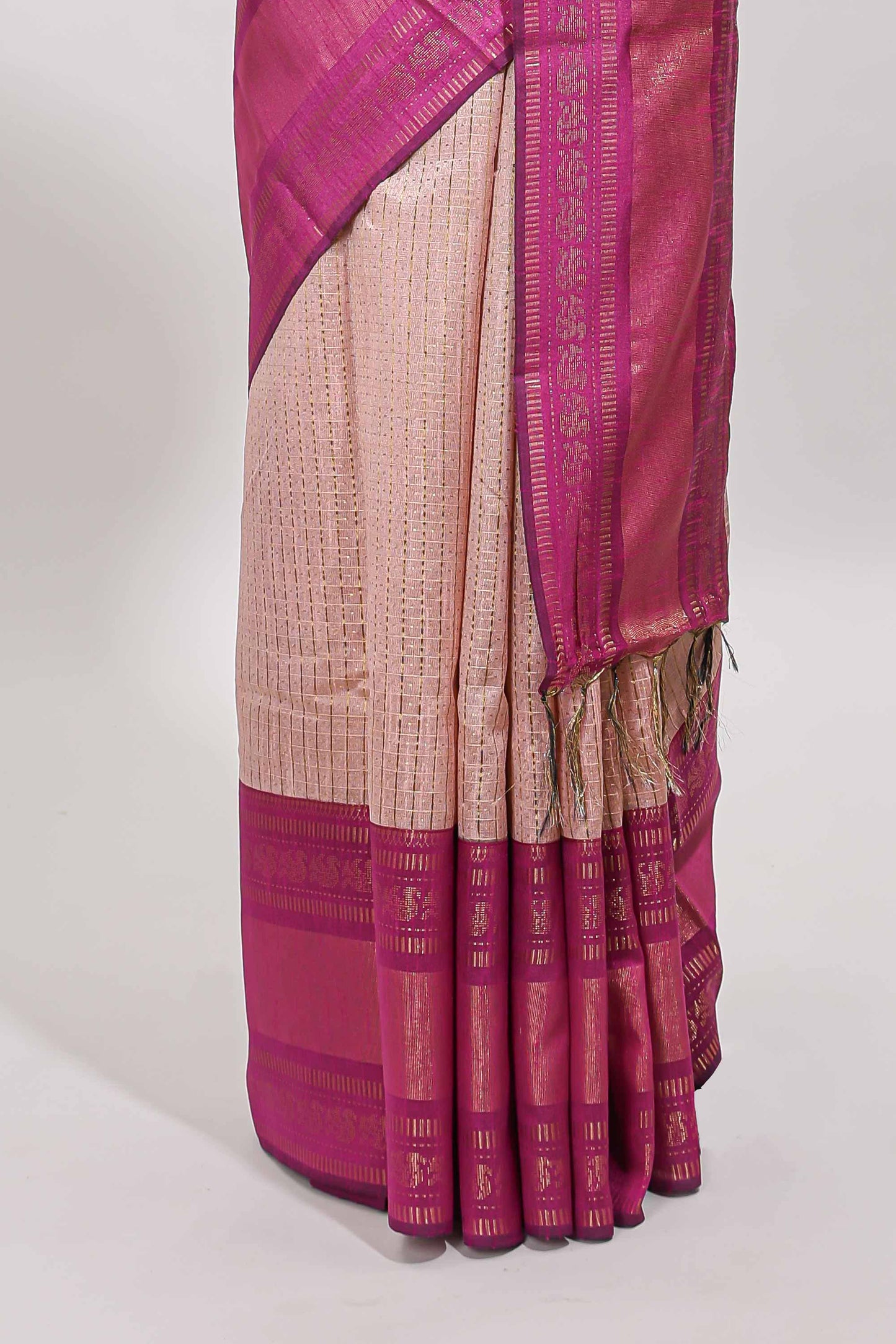 Beige checked tussar saree with contrast pink zari border and checked blouse
