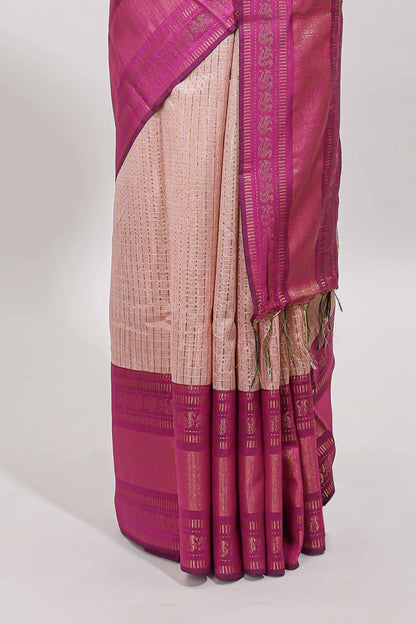 Beige checked tussar saree with contrast pink zari border and checked blouse