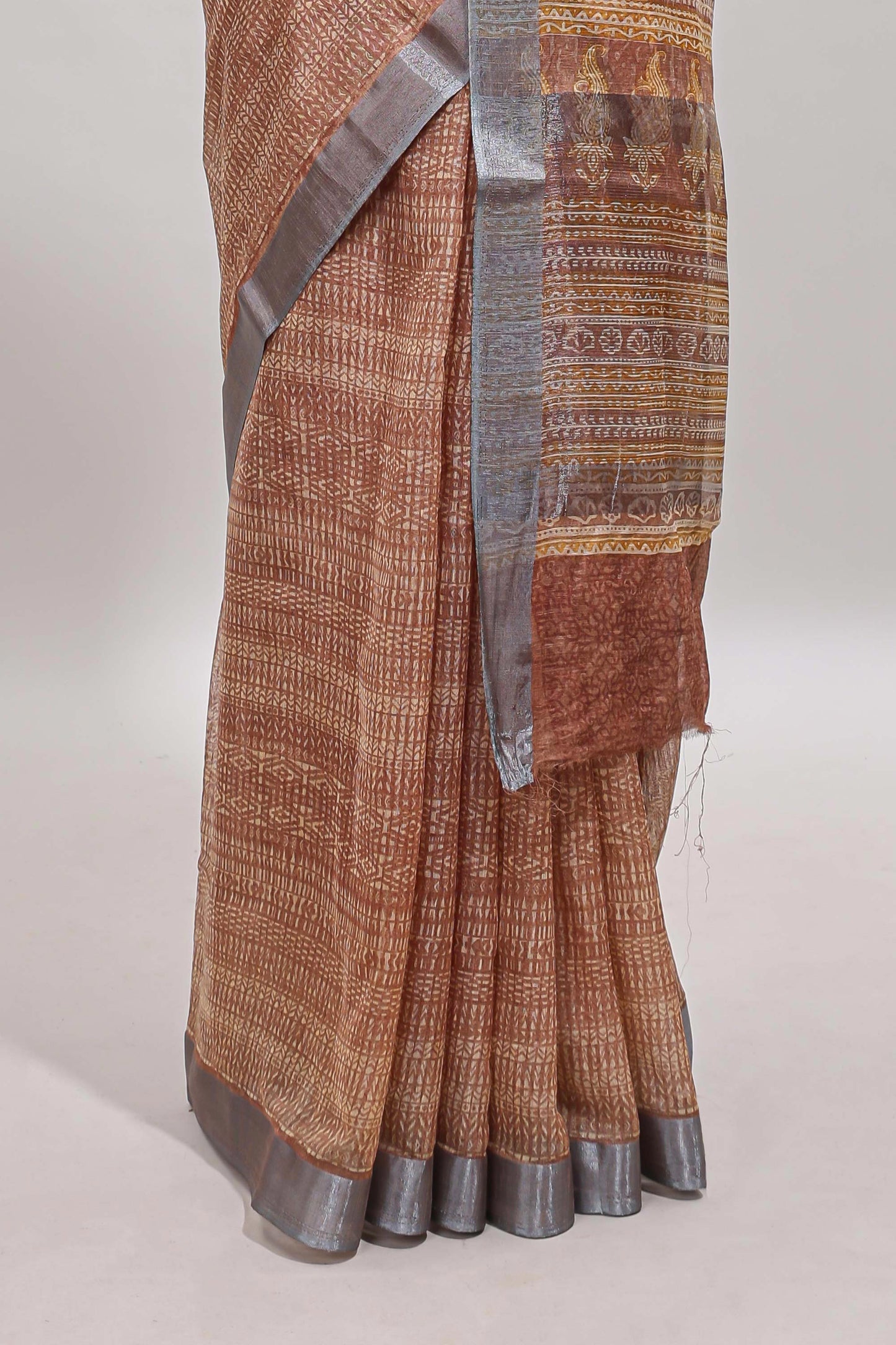 Brown geometric design semi tussar saree with contrast border and matching blouse