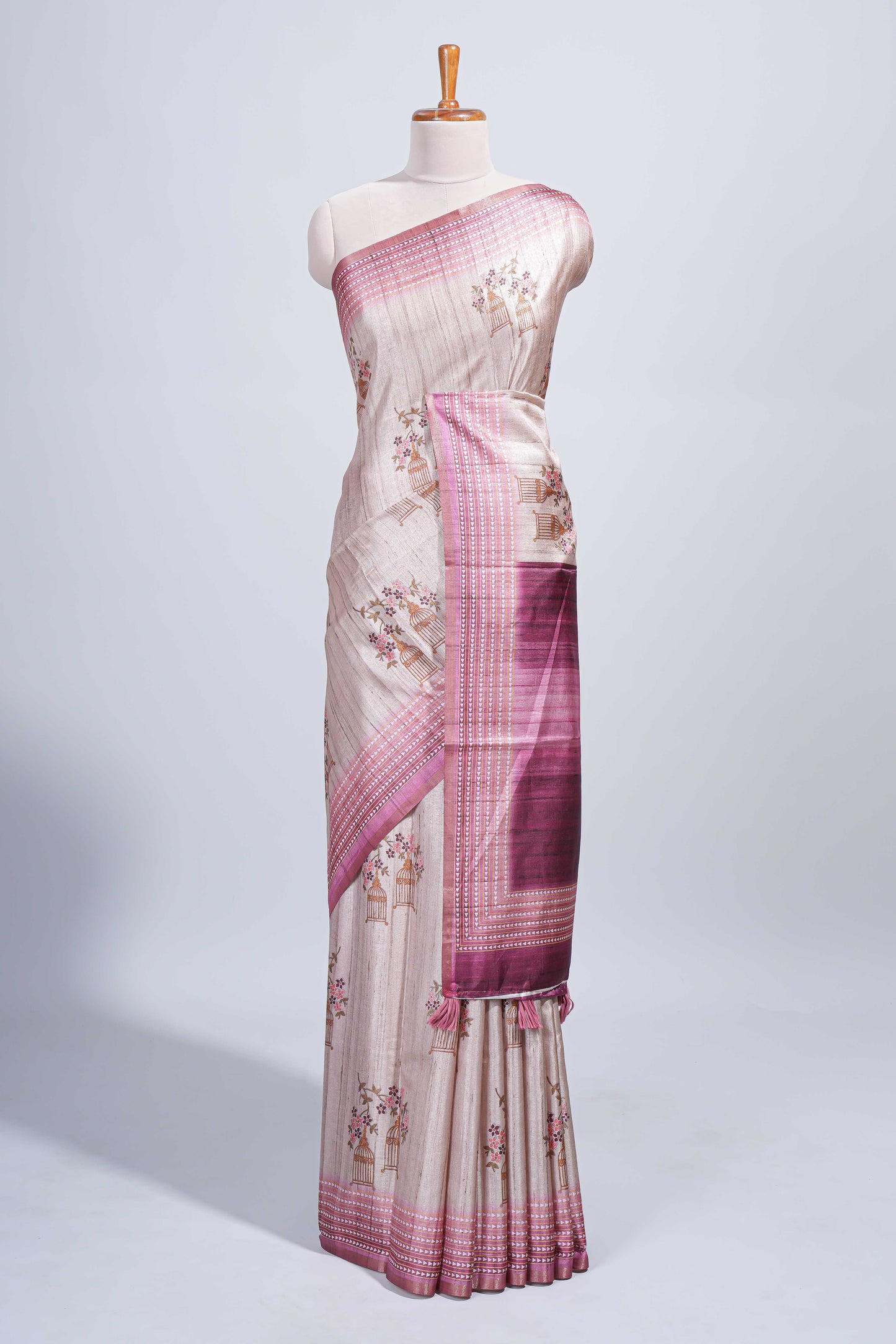 Beige floral & cage print motifs tussar saree with contrast border and blouse