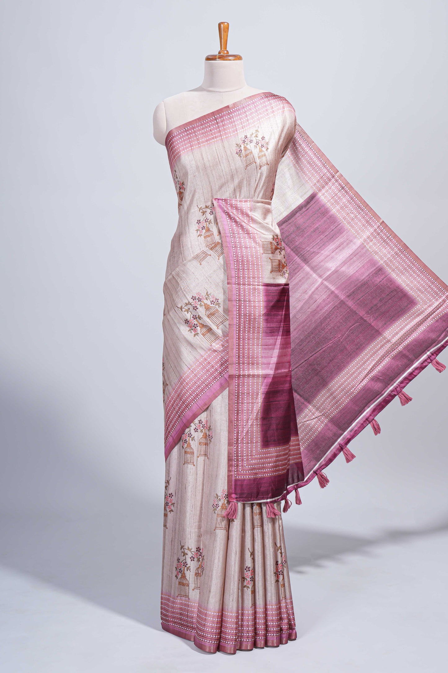Beige floral & cage print motifs tussar saree with contrast border and blouse