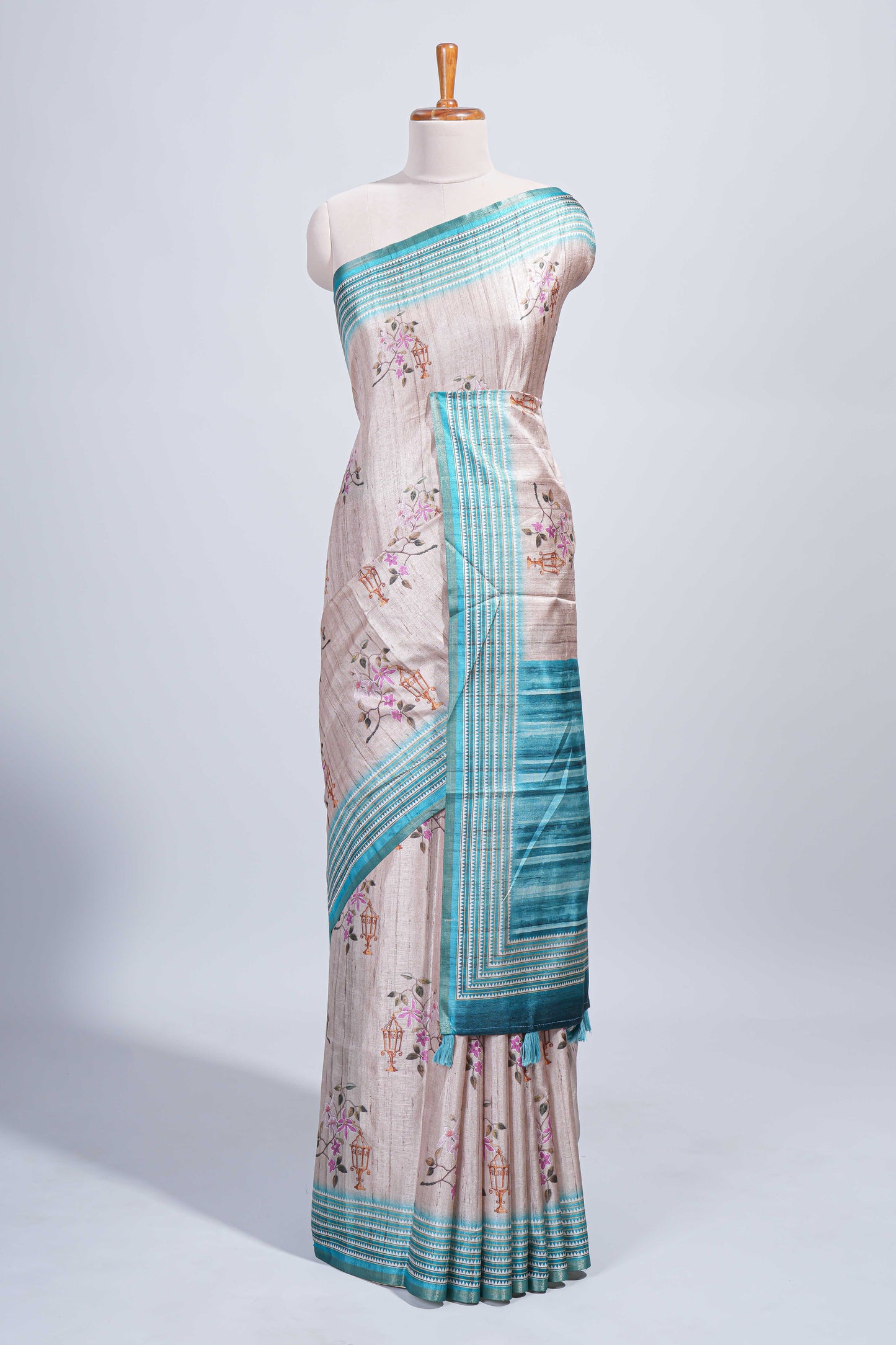 Beige floral & cage print motifs tussar saree with contrast border and blouse