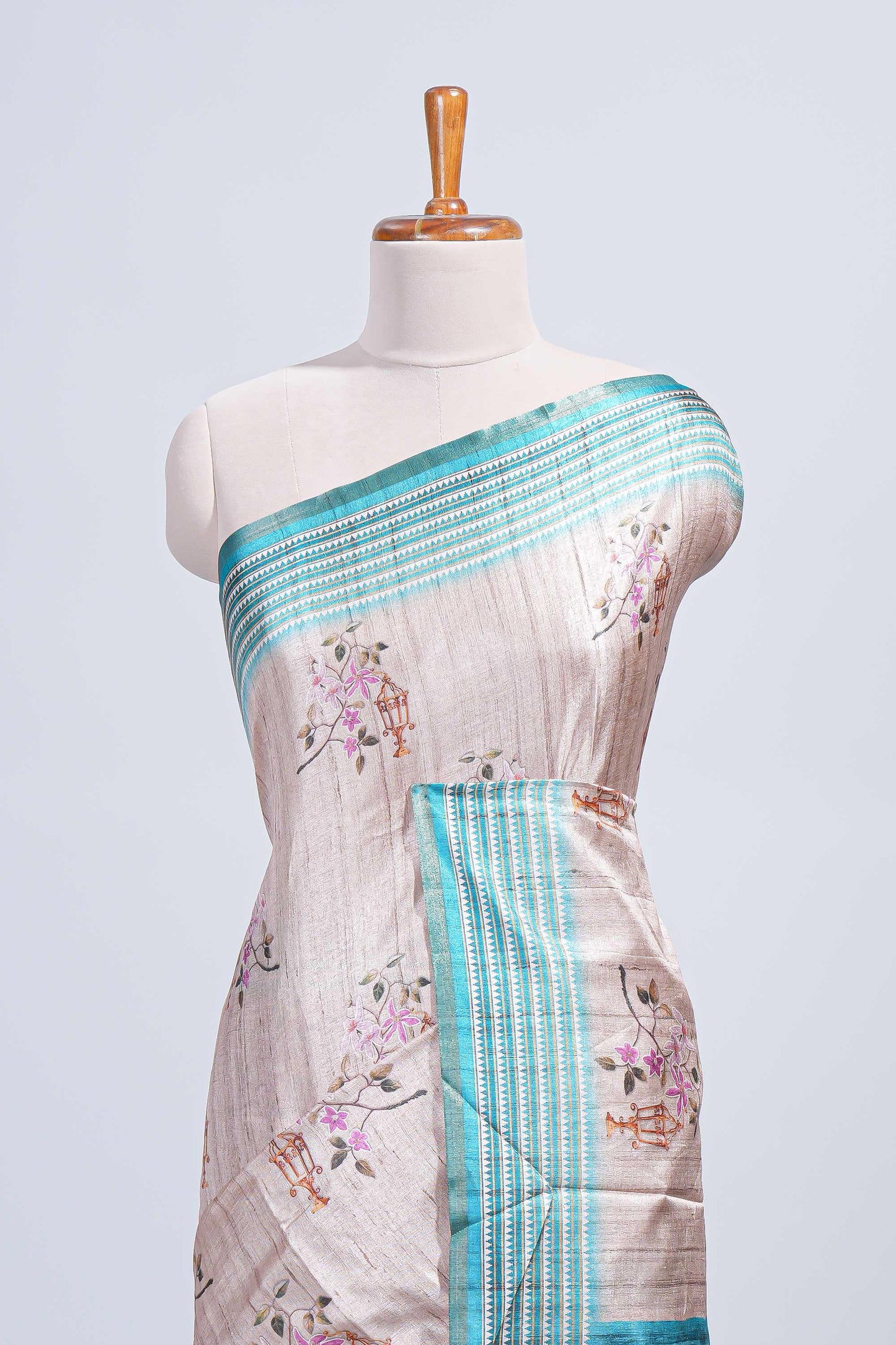 Beige floral & cage print motifs tussar saree with contrast border and blouse