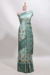 Turquoise green pichwai print tussar saree with contrast zari border and matching blouse