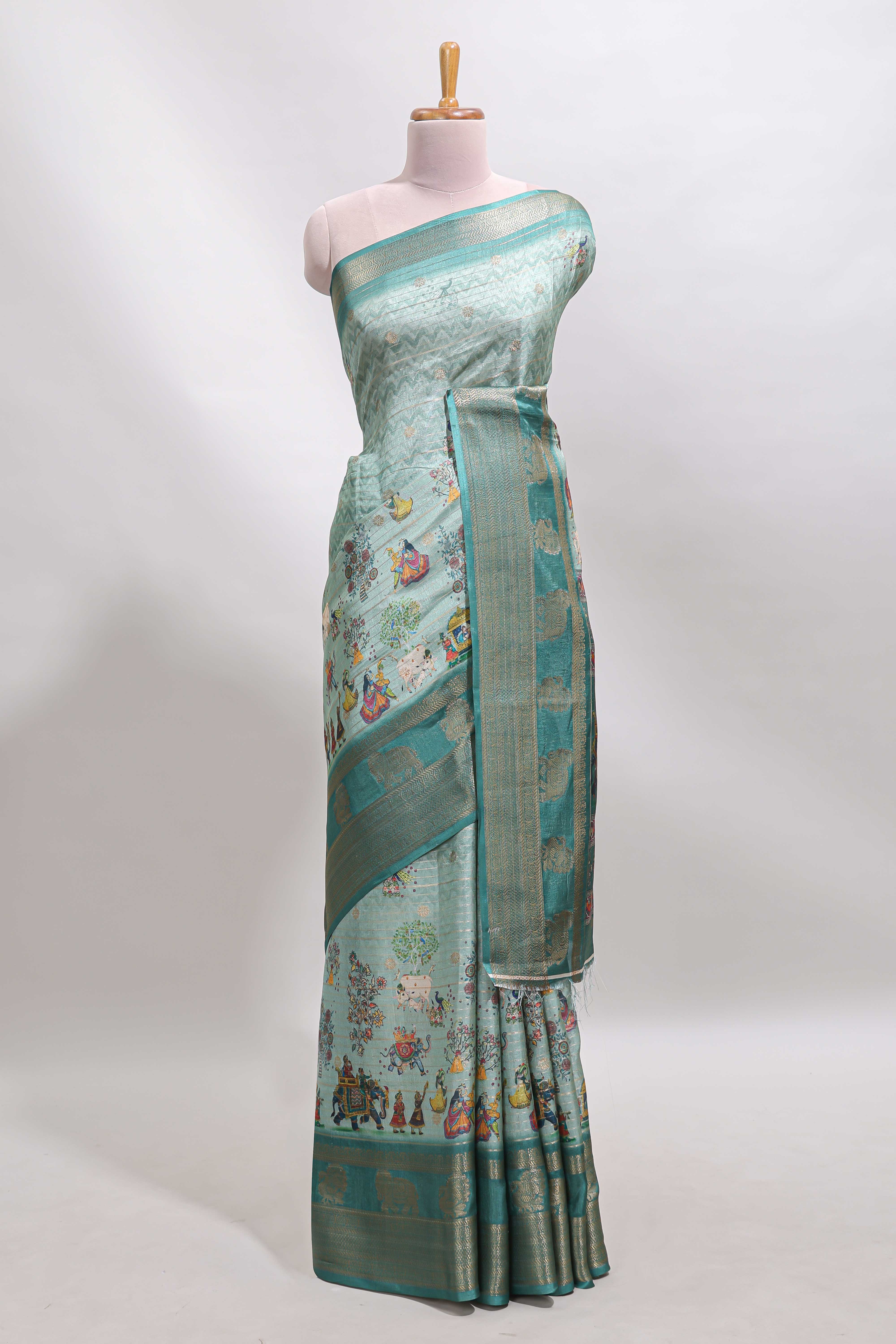 Turquoise green pichwai print tussar saree with contrast zari border and matching blouse