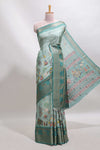 Turquoise green pichwai print tussar saree with contrast zari border and matching blouse