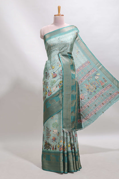 Turquoise green pichwai print tussar saree with contrast zari border and matching blouse
