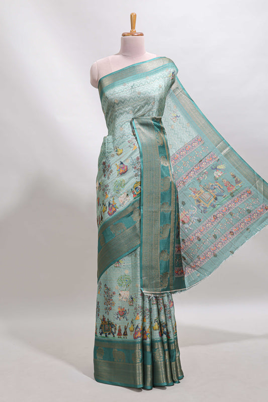 Turquoise green pichwai print tussar saree with contrast zari border and matching blouse