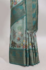 Turquoise green pichwai print tussar saree with contrast zari border and matching blouse