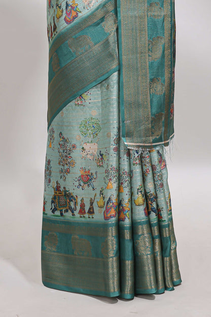 Turquoise green pichwai print tussar saree with contrast zari border and matching blouse