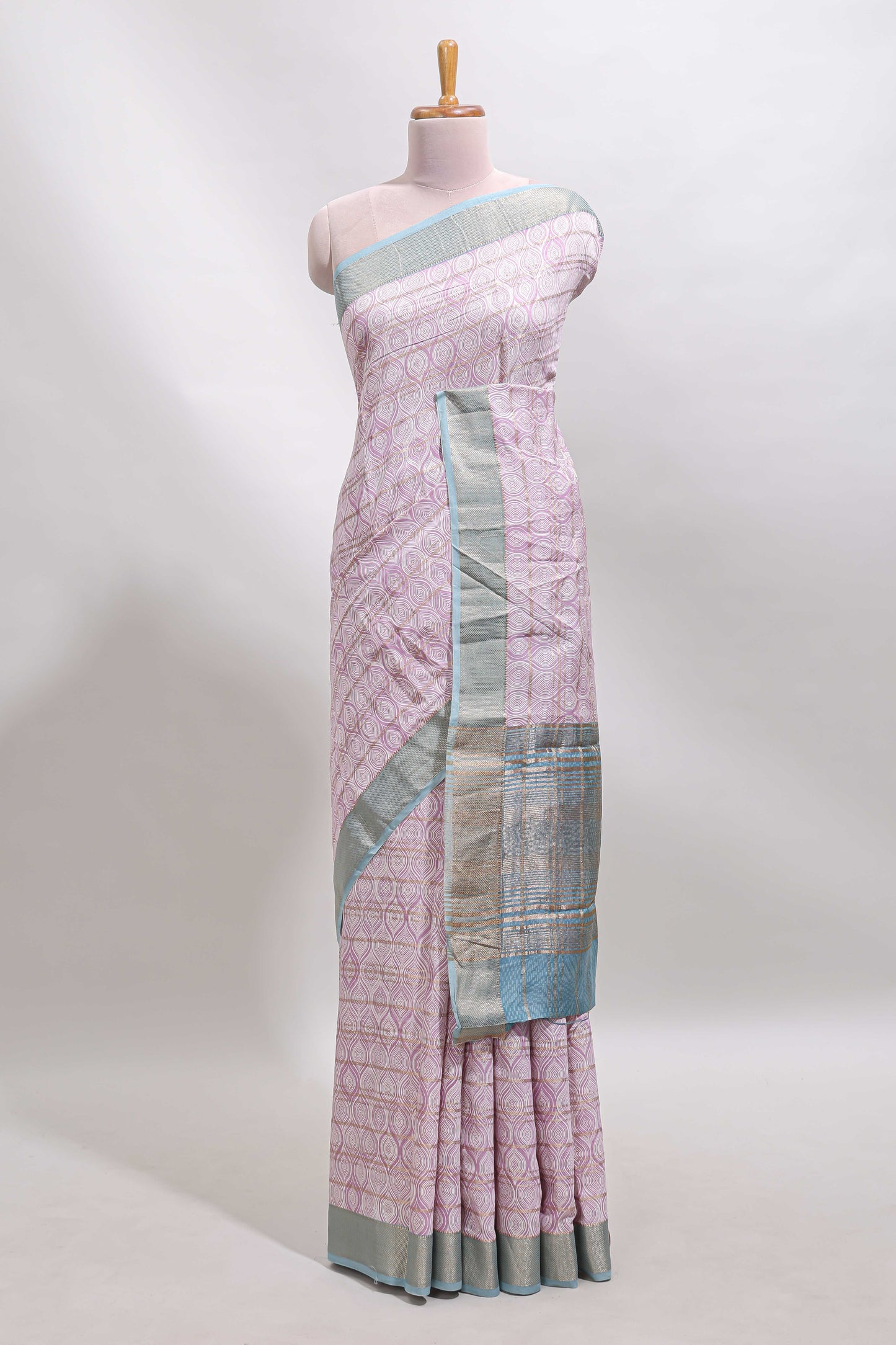 Baby pink geometric design tussar saree with contrast zari border and striped blouse