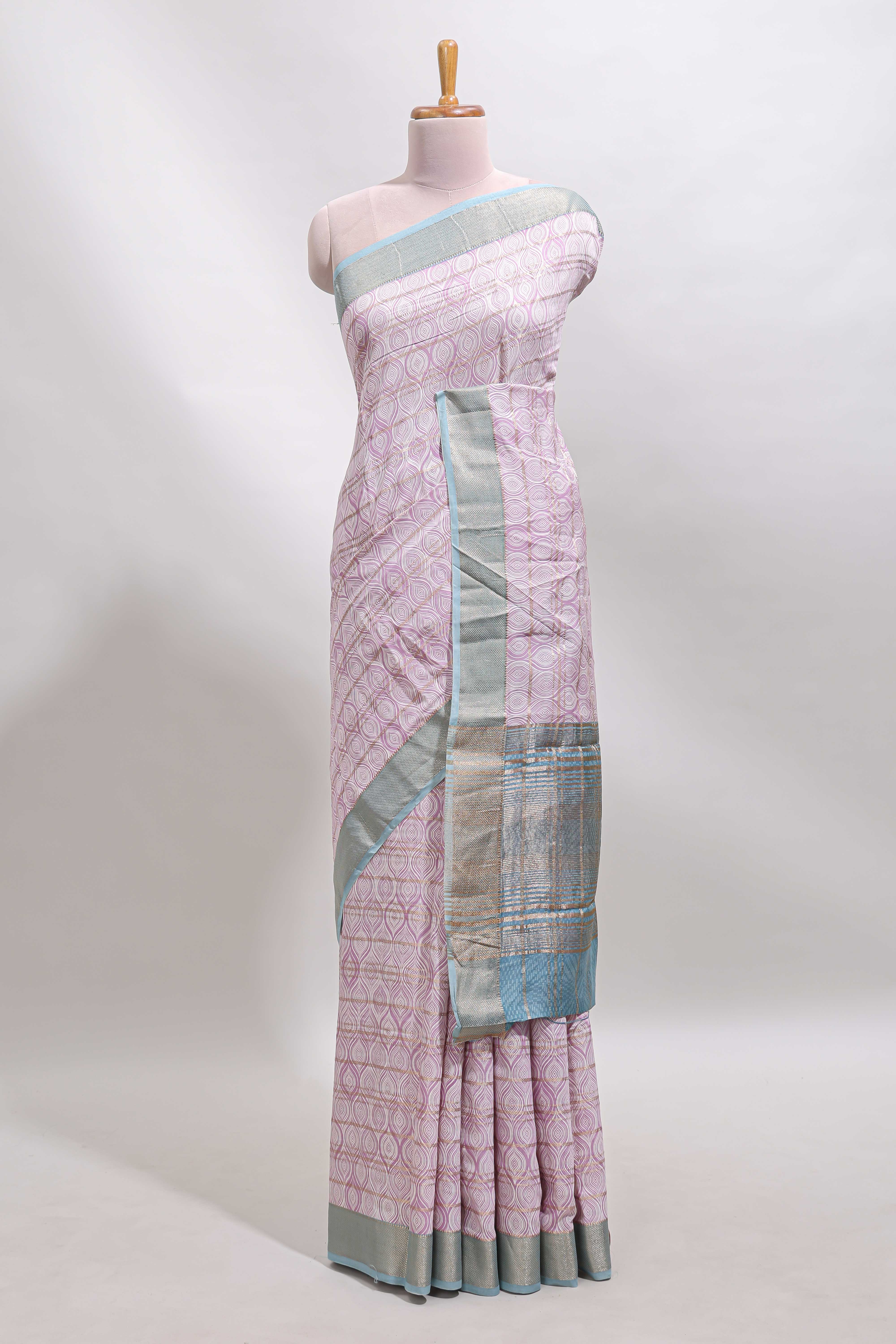 Baby pink geometric design tussar saree with contrast zari border and striped blouse