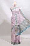 Baby pink geometric design tussar saree with contrast zari border and striped blouse
