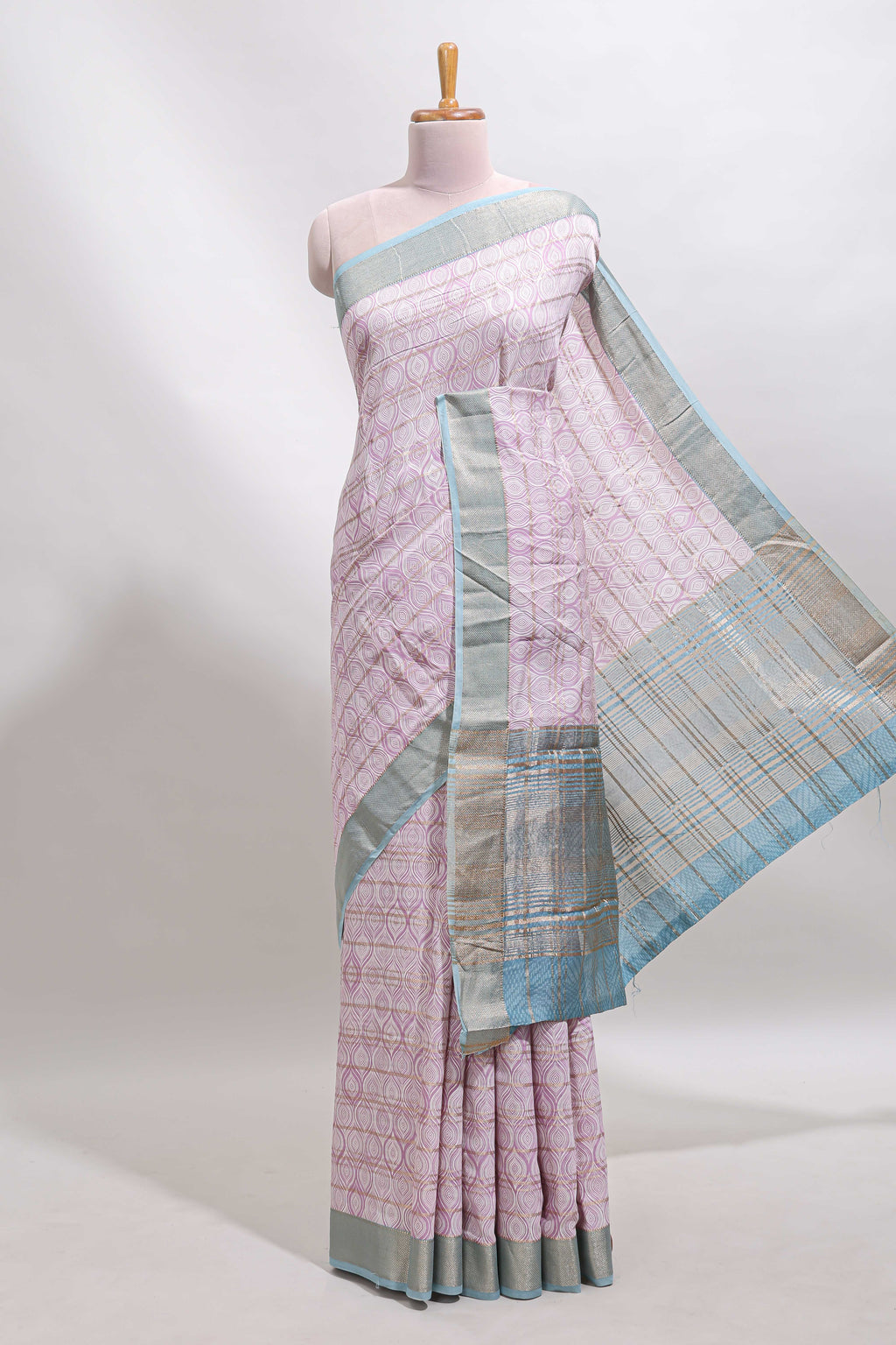 Baby pink geometric design tussar saree with contrast zari border and striped blouse