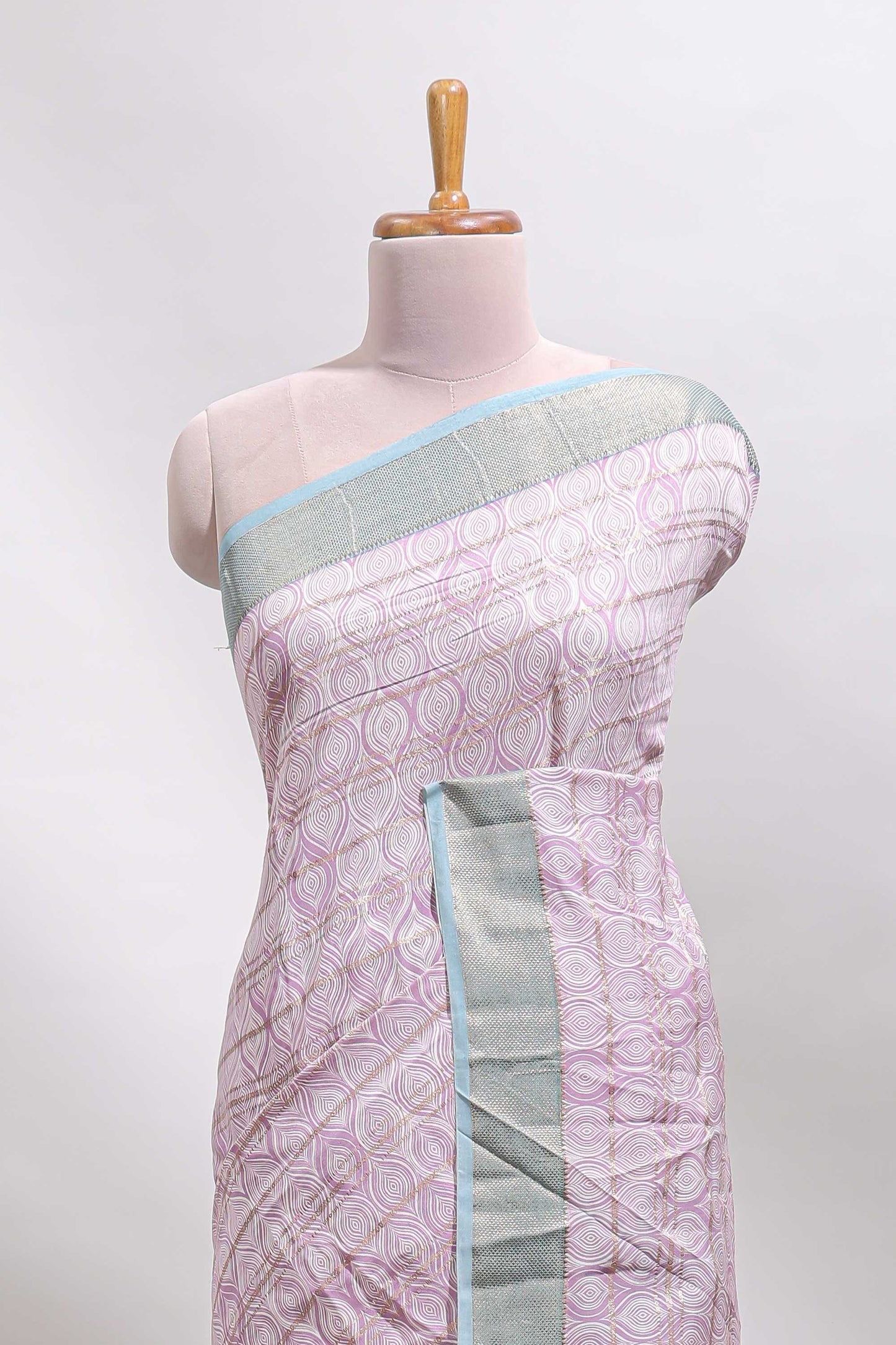 Baby pink geometric design tussar saree with contrast zari border and striped blouse