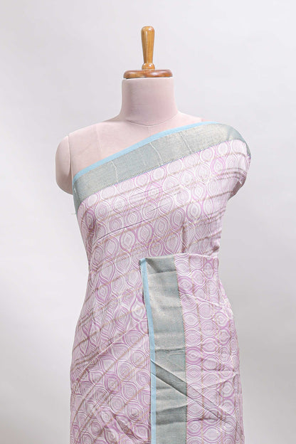 Baby pink geometric design tussar saree with contrast zari border and striped blouse