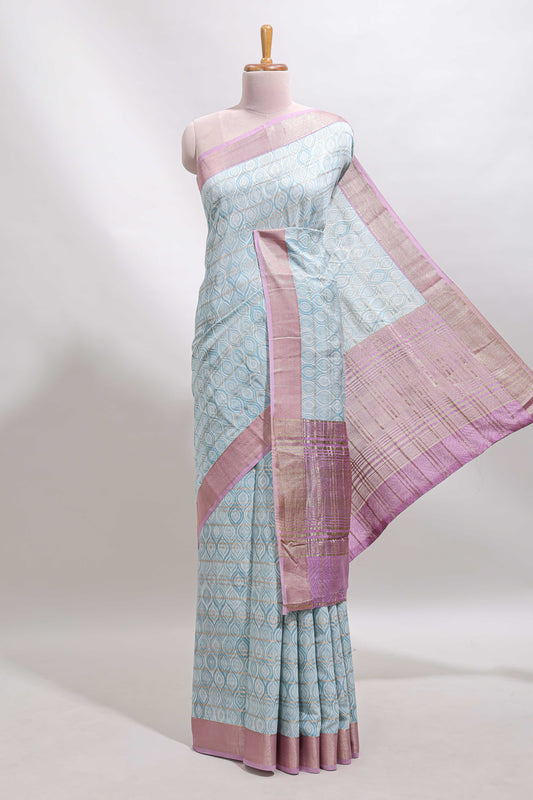 Blue geometric design tussar saree with contrast zari border and striped blouse