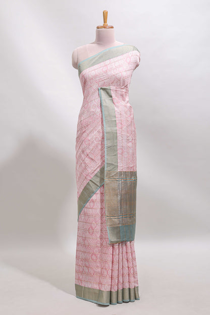 Peach geometric design tussar saree with contrast zari border and striped blouse