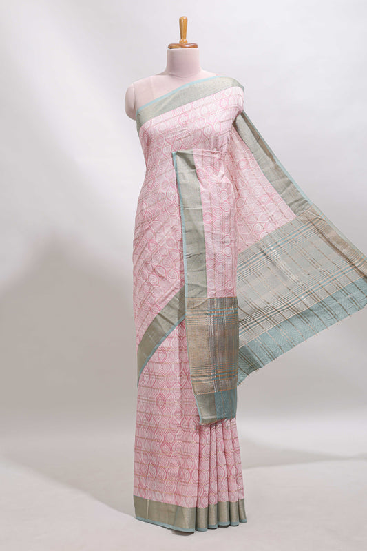 Peach geometric design tussar saree with contrast zari border and striped blouse