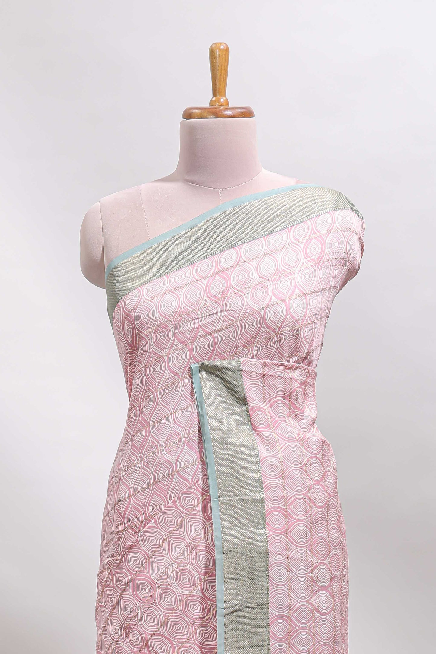 Peach geometric design tussar saree with contrast zari border and striped blouse