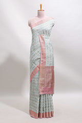 Green geometric design tussar saree with contrast zari border and striped blouse