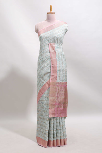 Green geometric design tussar saree with contrast zari border and striped blouse