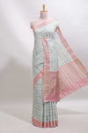 Green geometric design tussar saree with contrast zari border and striped blouse