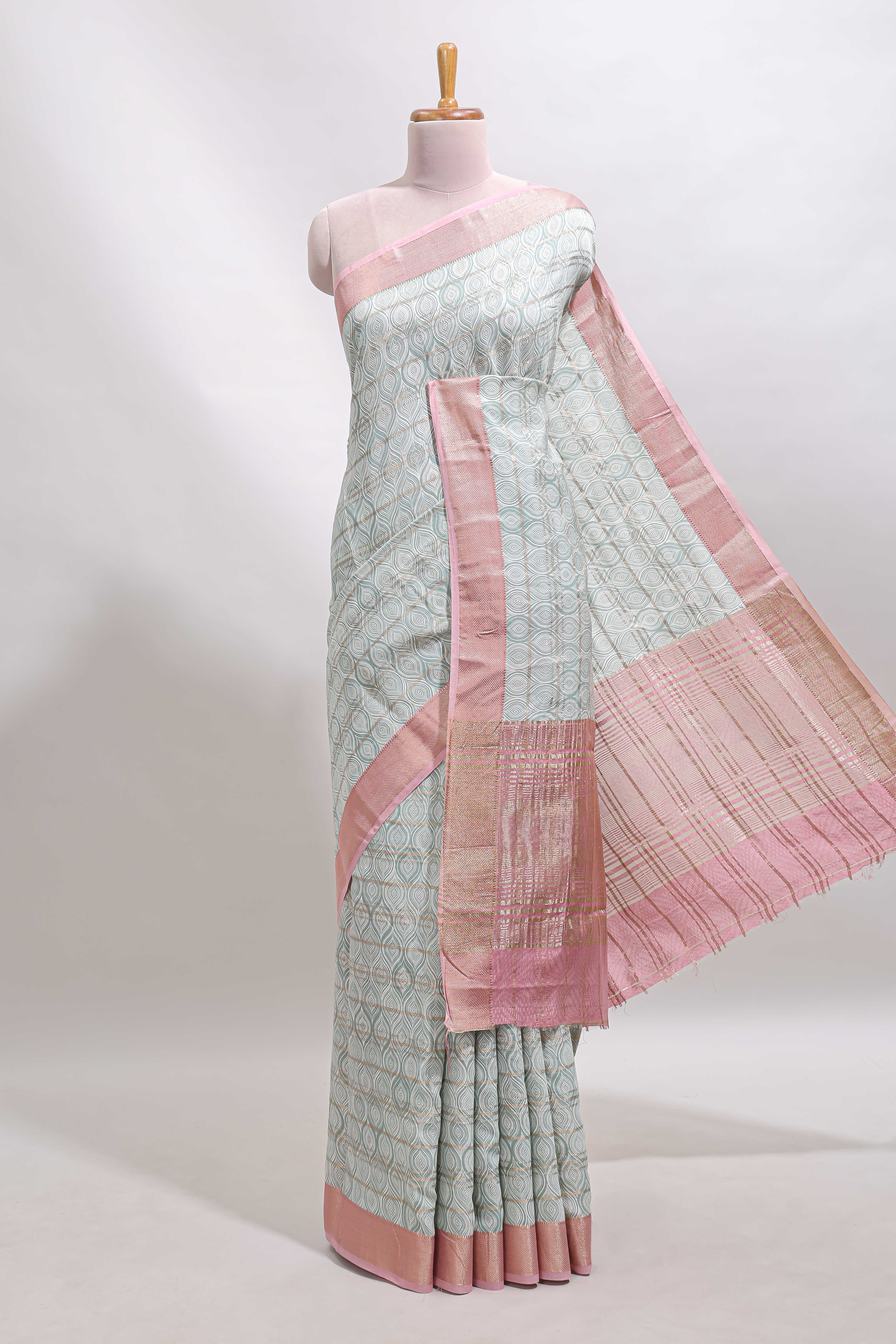 Green geometric design tussar saree with contrast zari border and striped blouse