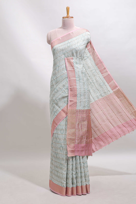 Green geometric design tussar saree with contrast zari border and striped blouse