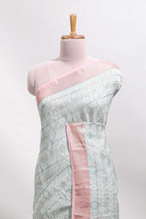 Green geometric design tussar saree with contrast zari border and striped blouse